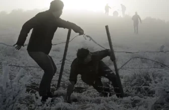 dois homens sobre uma cerca