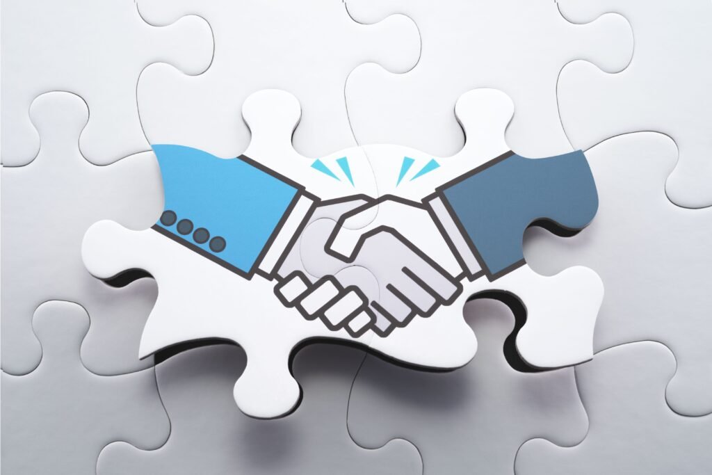 Ilustração de mãos sendo apertadas em um quebra cabeças.