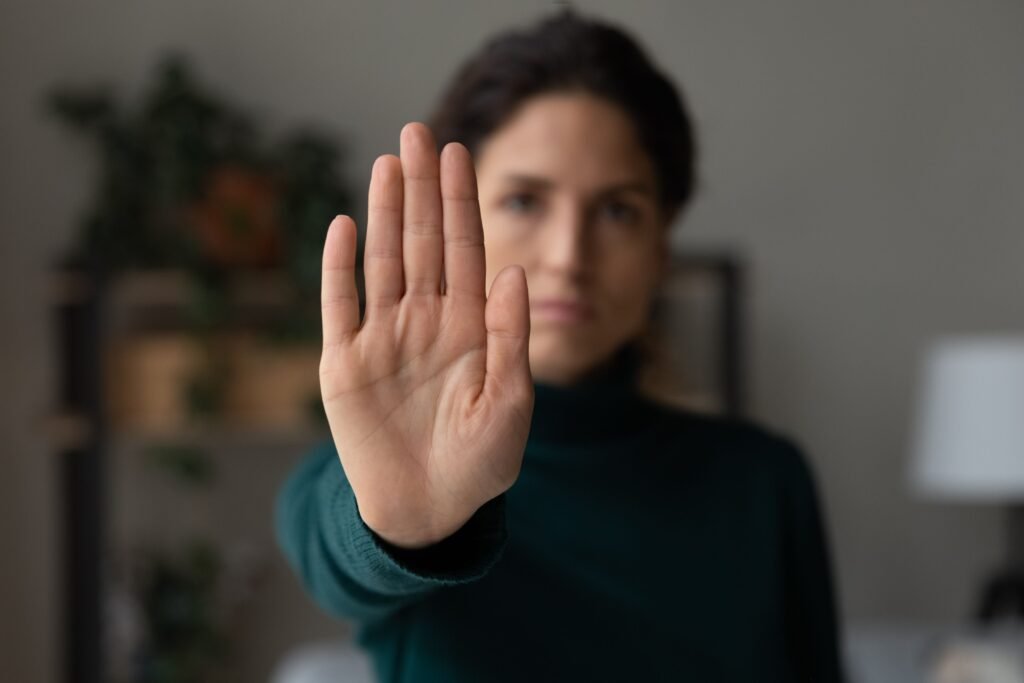 Mulher fazendo sinal de "pare"