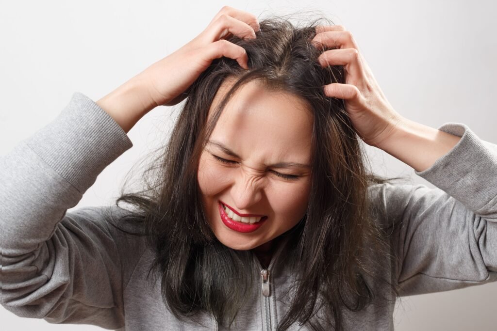 Mulher coçando o cabelo.