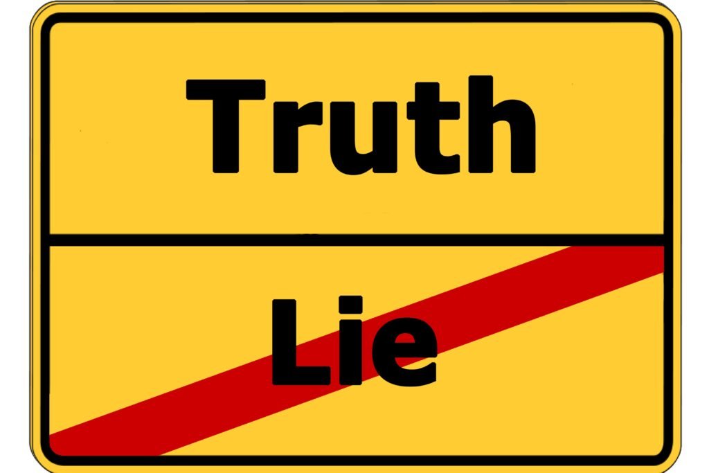 Placa amrela com as palavras "truth" e "lie".
